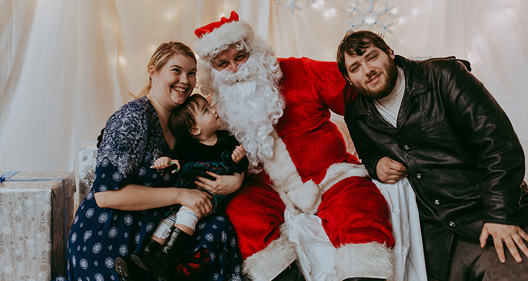 A family posing for a photo with Santa Claus.